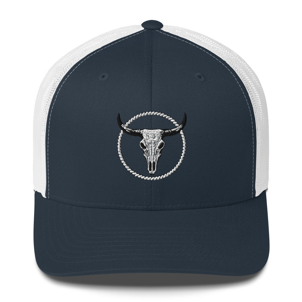 Black and white MNTAIN Trucker hat with bull skull emblem on front and mesh back panels